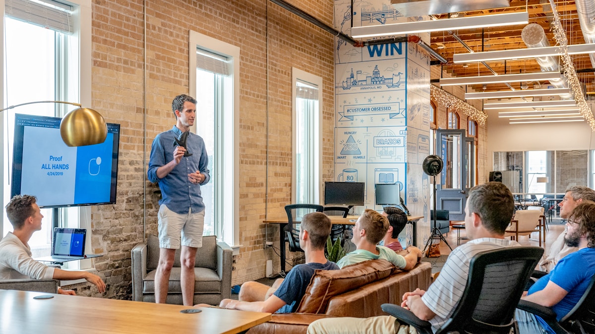 Small group receiving facilitator feedback during a profit AI lab session